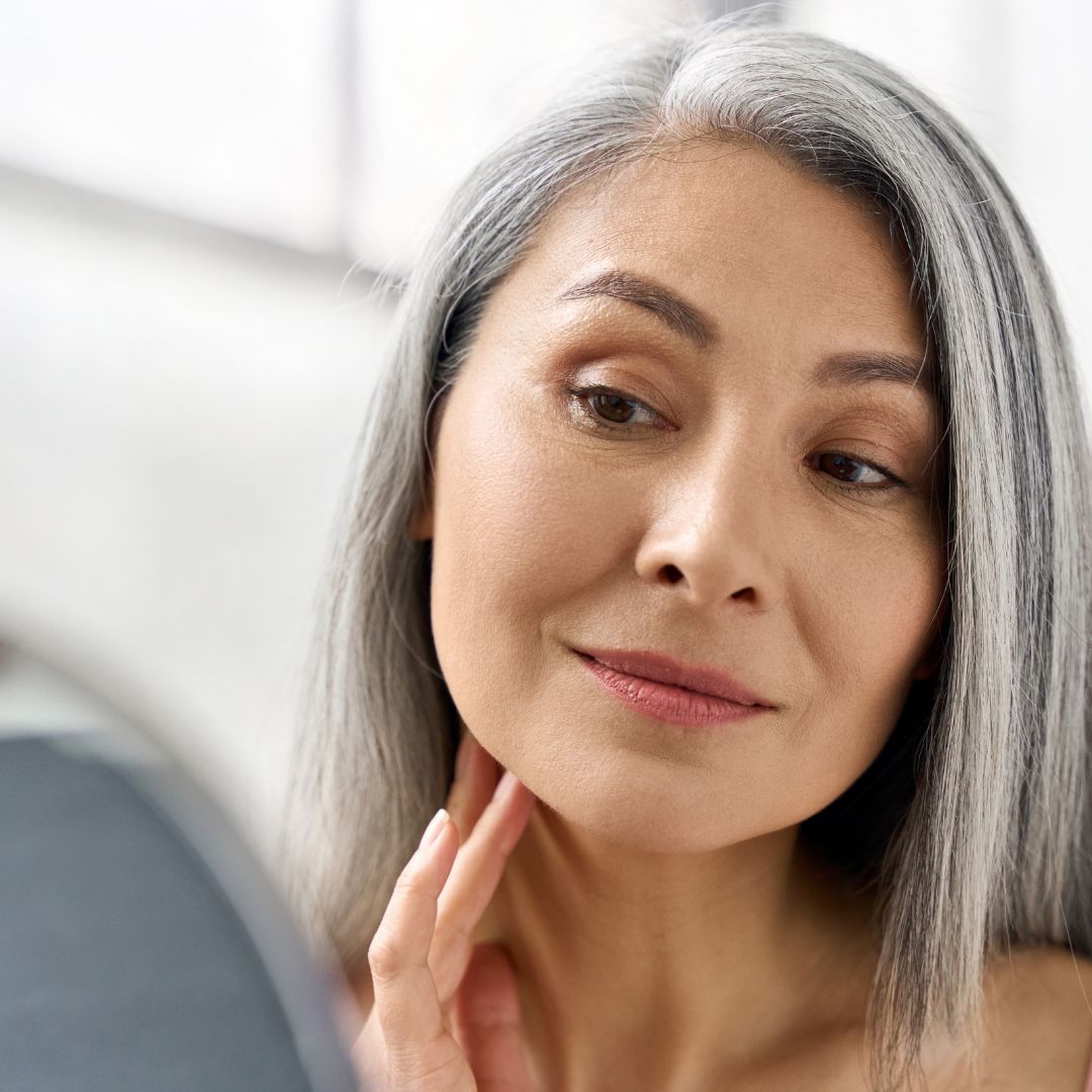 Woman looking at her rejuvenated skin