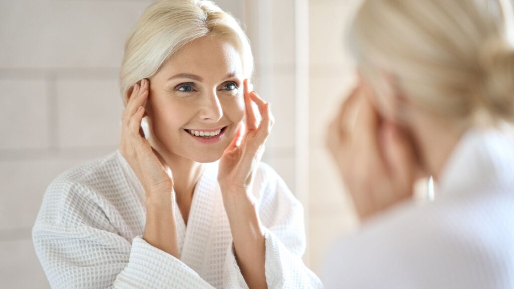 Mature woman admiring her skin