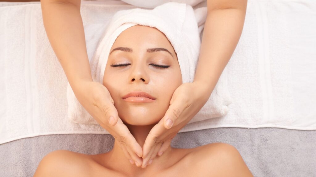 Skincare specialist massaging patient's skin