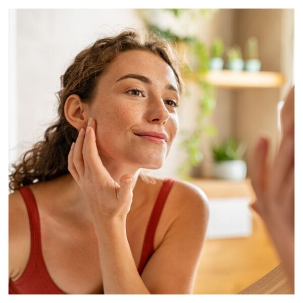 woman looking at skin