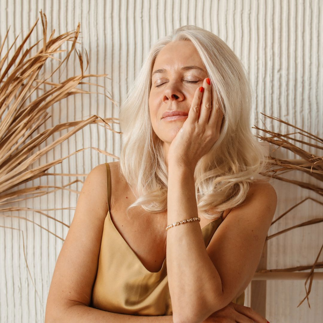 an older woman admiring her face
